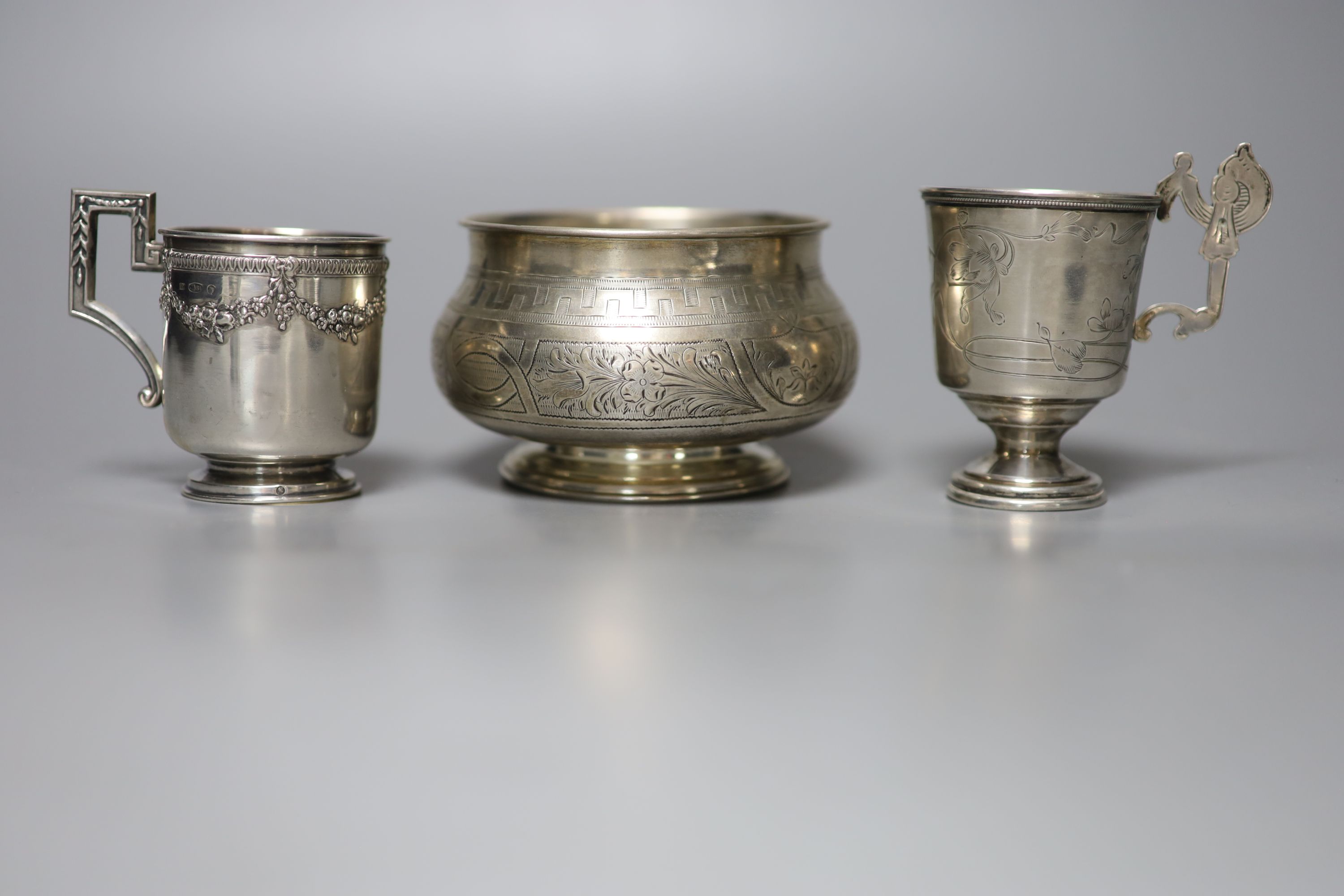 Two early 20th century Russian 84 zolotnik cups and saucers, one other saucer, napkin ring and sugar bowl